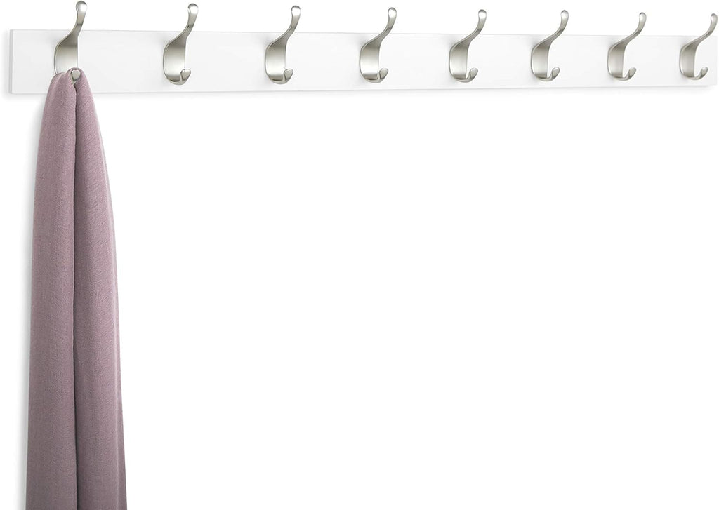 White wall-mounted coat rack with hooks holding a purple scarf on a white background