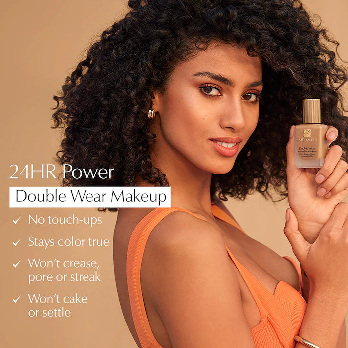 Woman holding a bottle of makeup with product features listed on a beige background