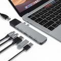 A silver USB-C hub adapter shown with a laptop keyboard and several attached and nearby USB-C and USB-A cables on a white background. The text 'DESKTOP ACCESSORIES' appears at the bottom right.